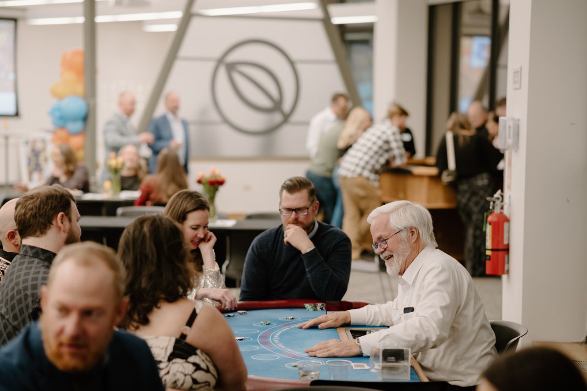 Team members gathered around the blackjack table