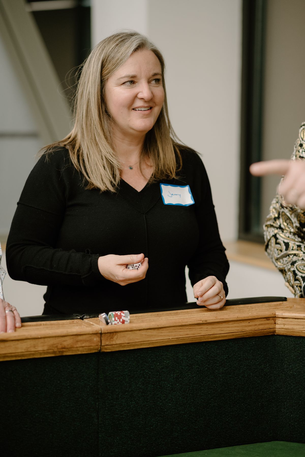 Team member rolling dice at the craps table
