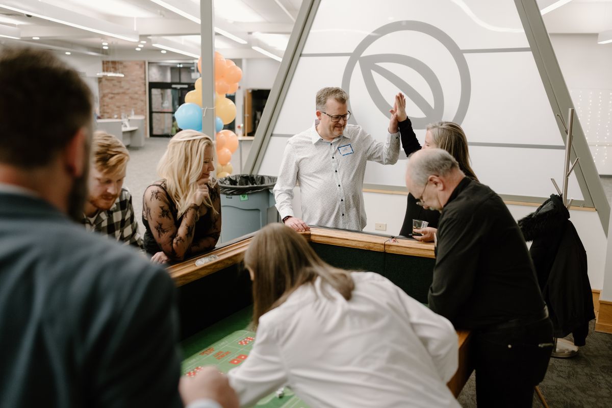 Team members high-fiving at the craps table