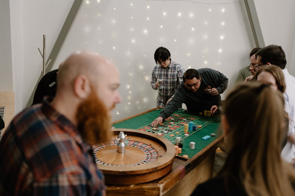 Team members placing bets at the roulette table