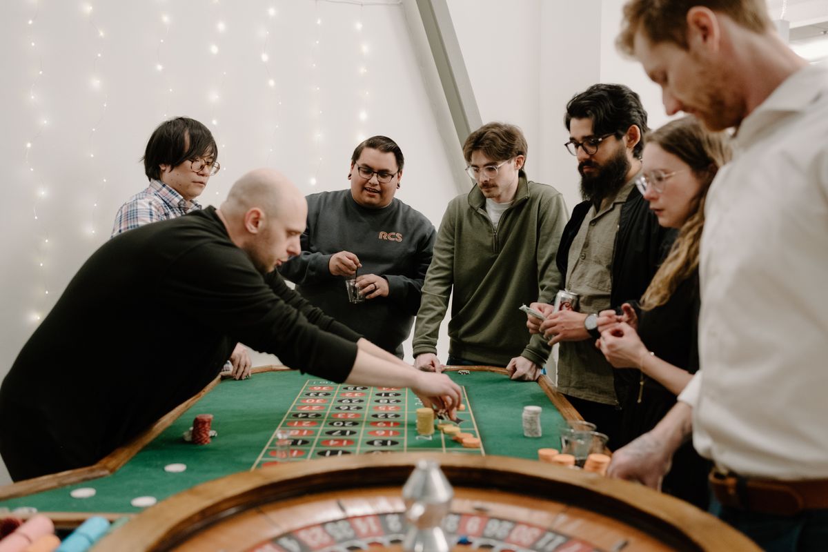 Group gathered around the roulette table