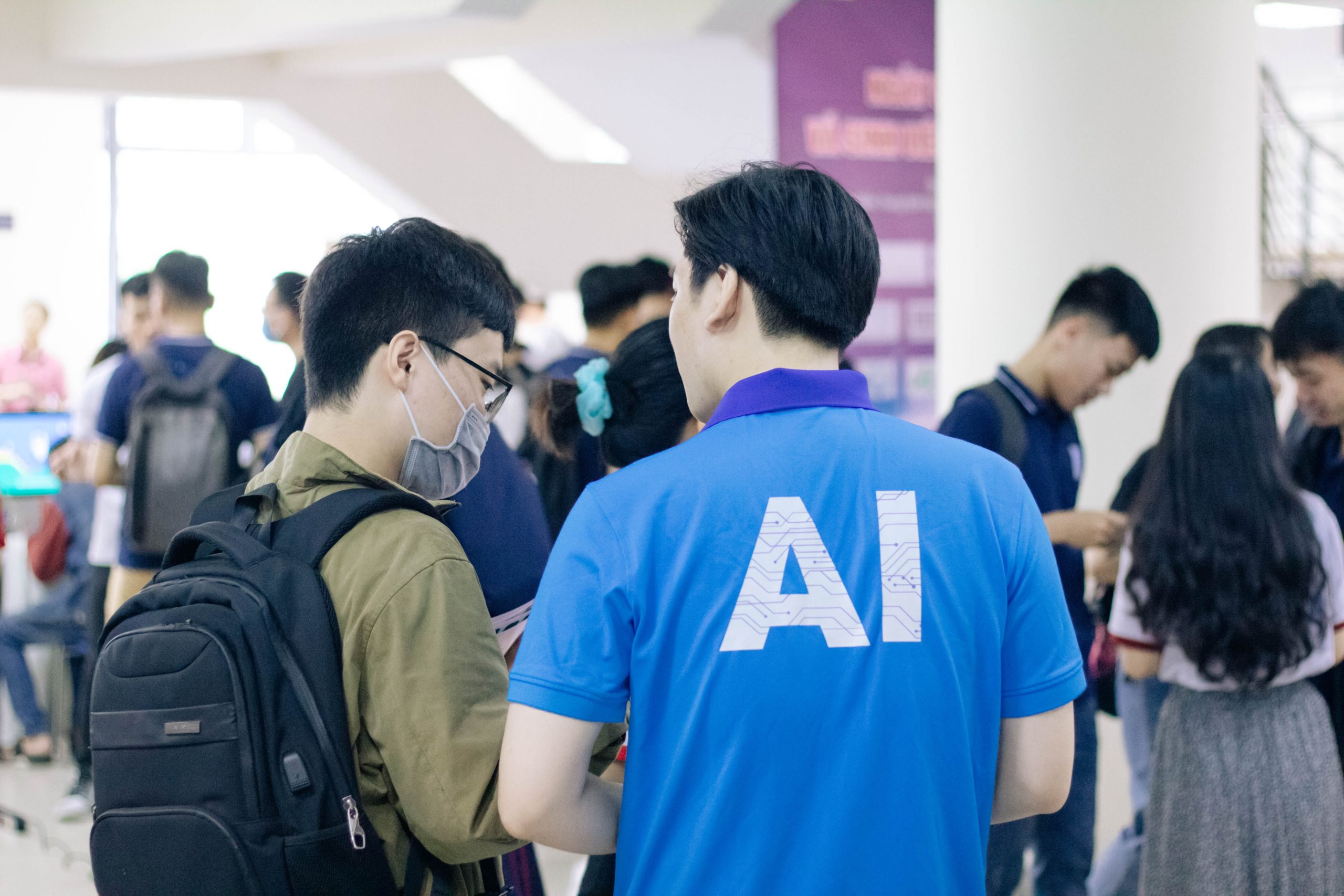 Two people standing together with one having an artificial intelligence shirt