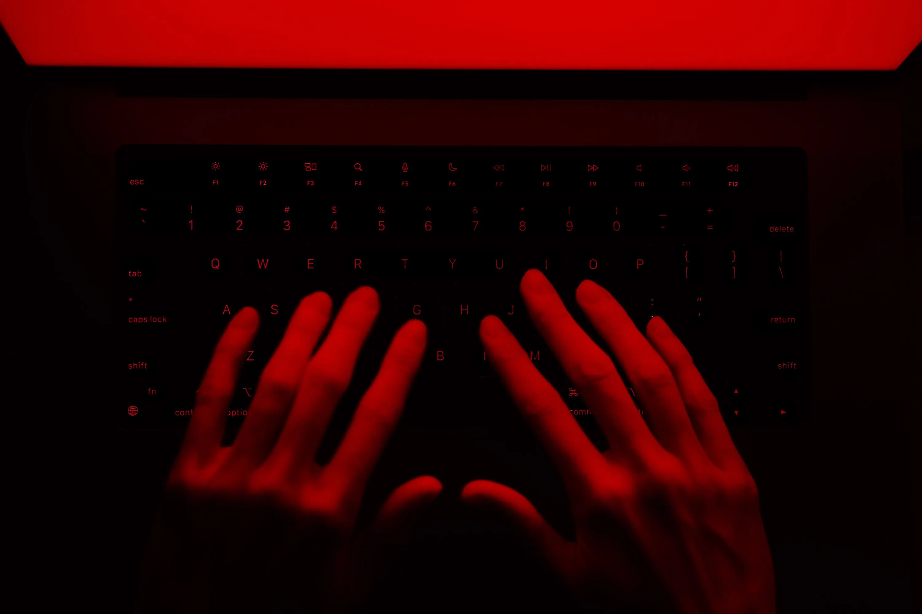 ransomware hacker causing threat typing on laptop
