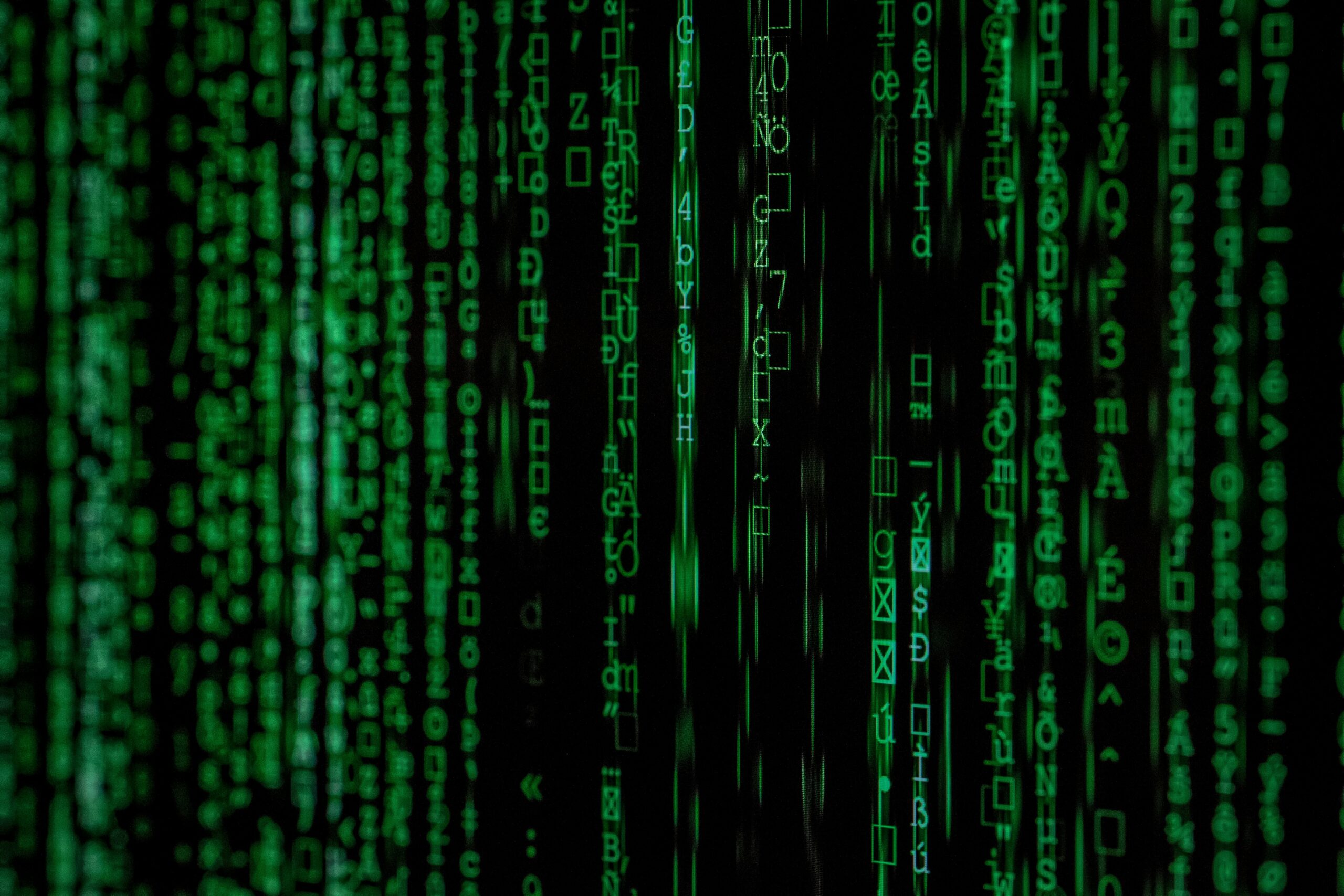A close up of a green matrix code displaying encrypted cybersecurity questions for a CISO.