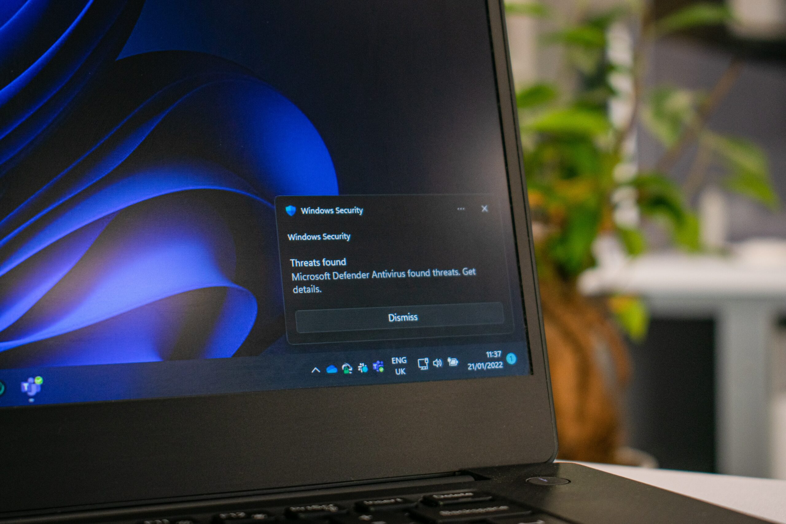 A laptop with a blue screen, requiring an antivirus scan.