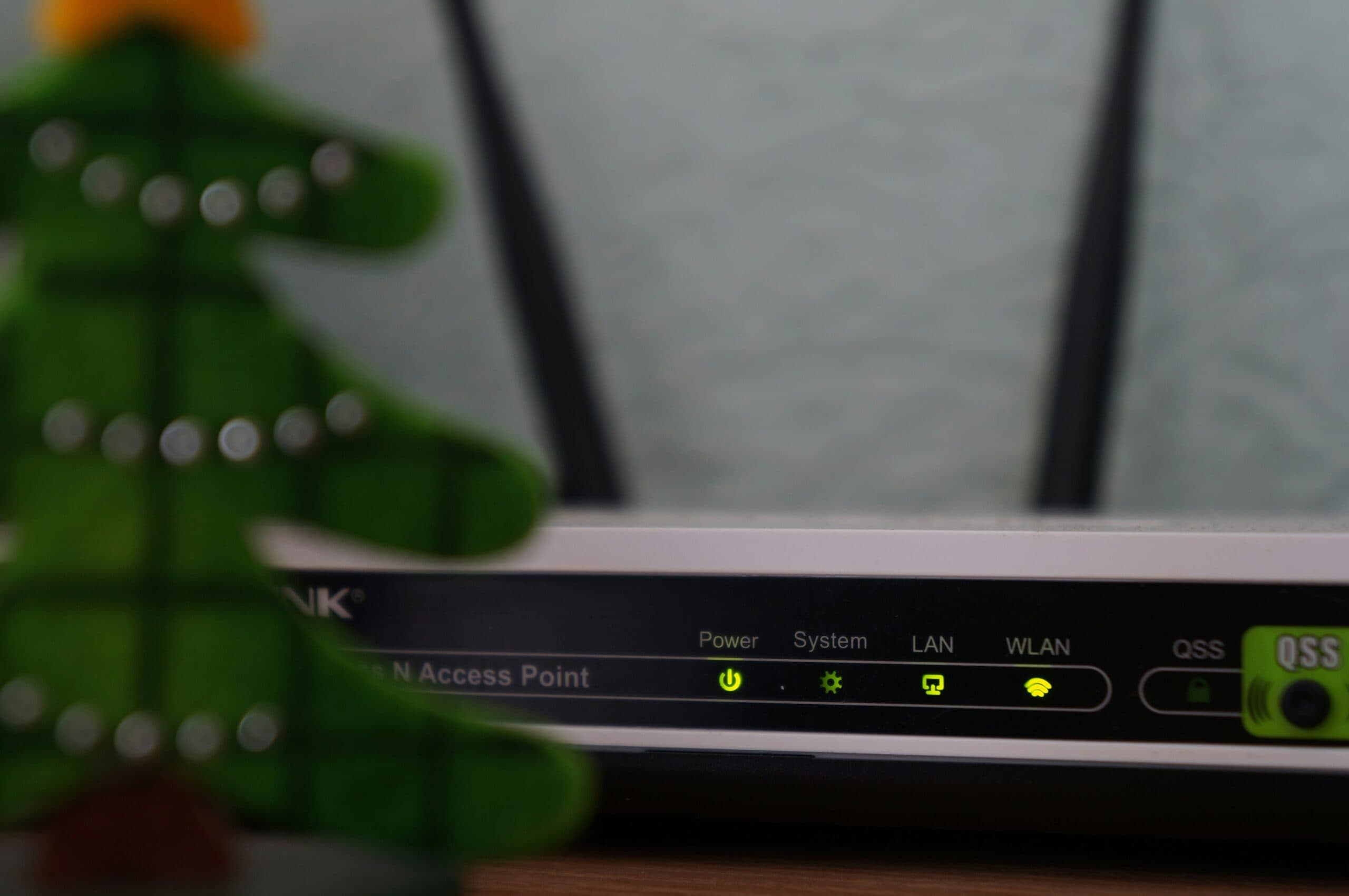 A christmas tree sits on top of a router for a secure home wireless network for teleworking.