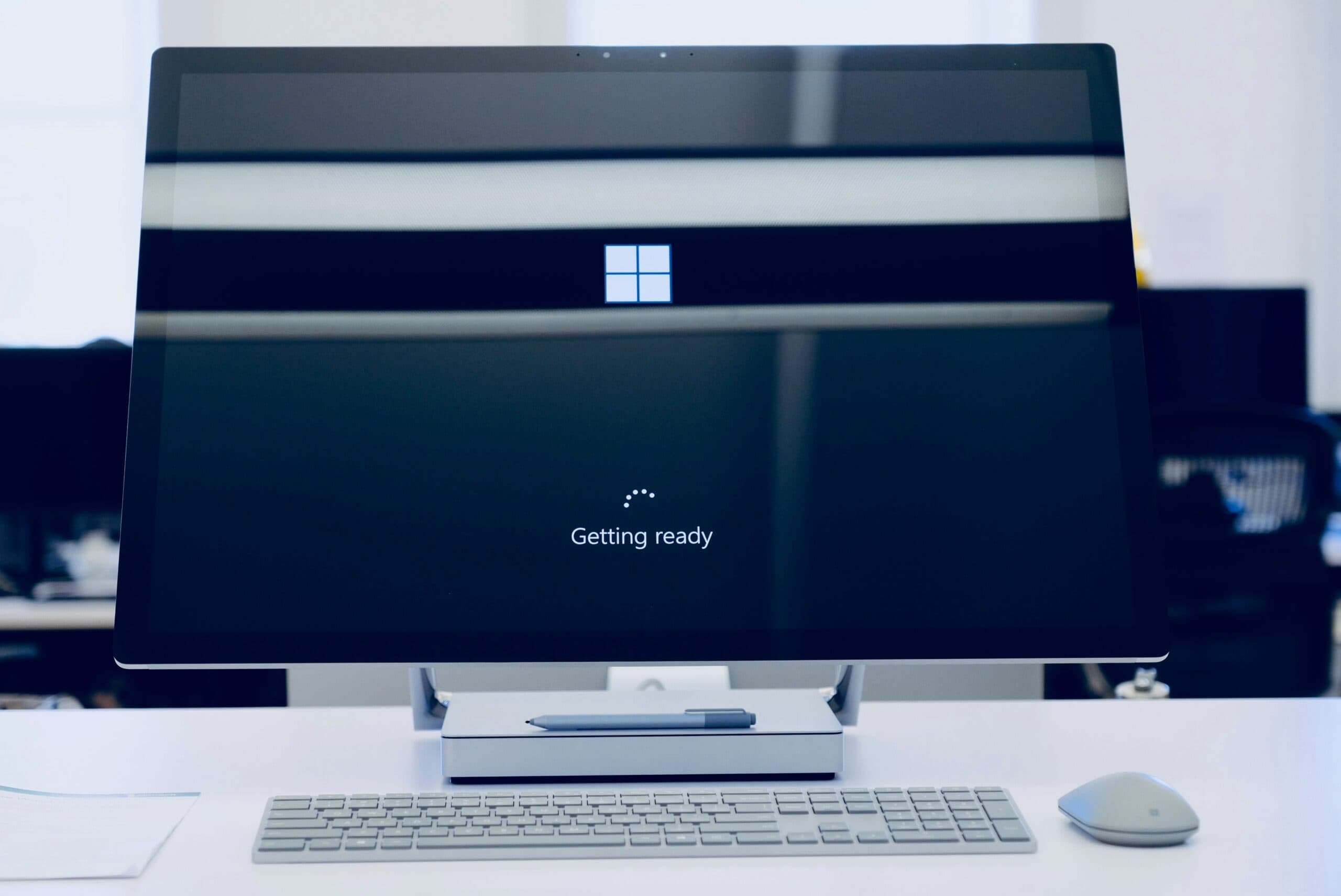 A Microsoft desktop computer is sitting on top of a desk with the loading page on display after user reset Microsoft password.