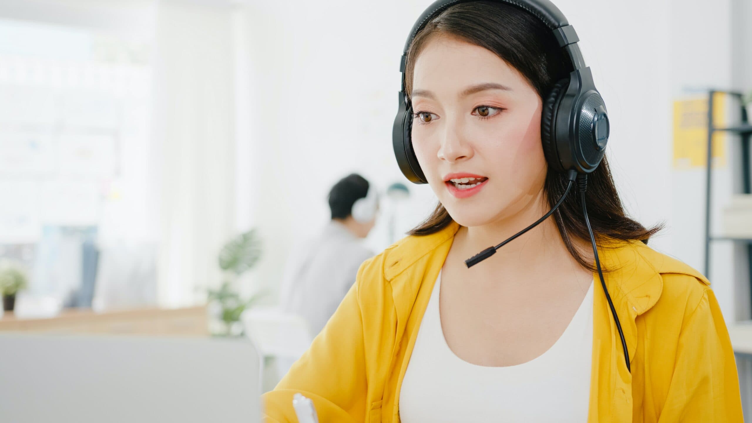 Woman in headset providing technical support in the office for ConnectWise password reset.