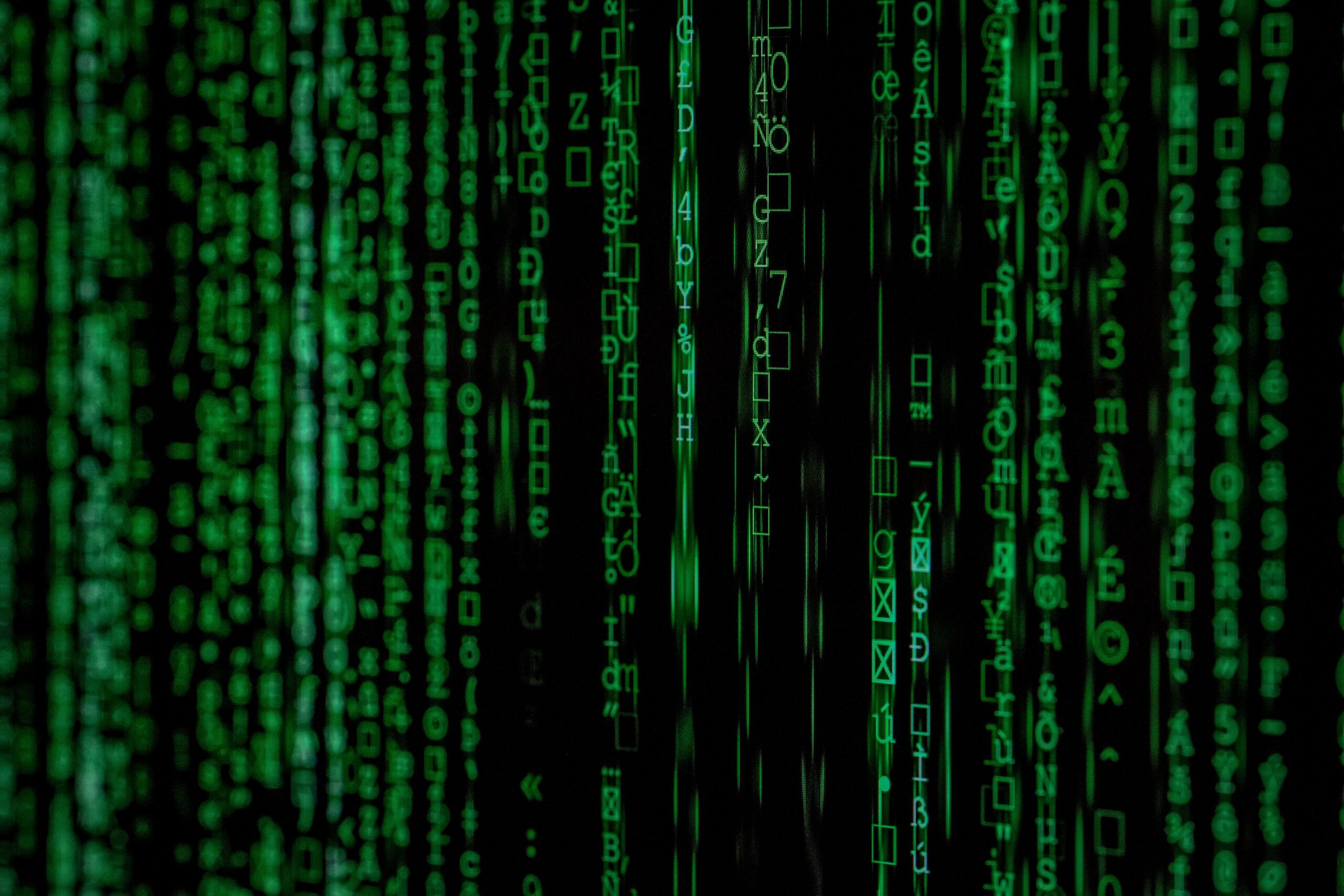A close up of a green matrix code, representing encryption for cyber security.