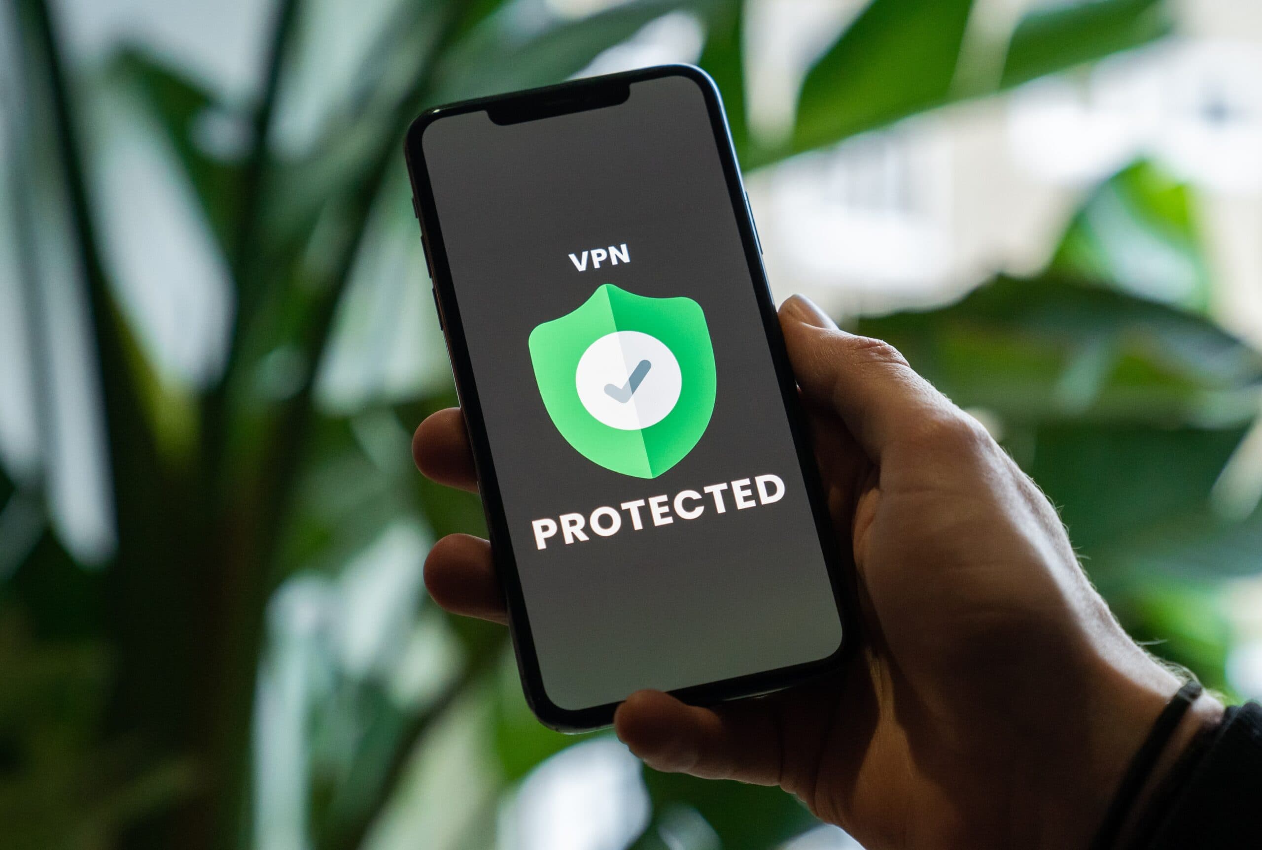 A person holding up a phone with the word protected on it, exploring the importance of online privacy.