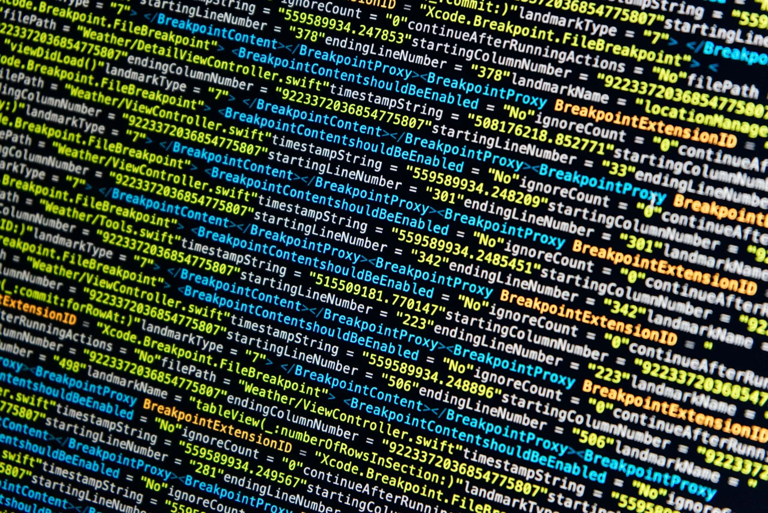 A close up of code on a computer screen, showcasing the importance of cybersecurity.