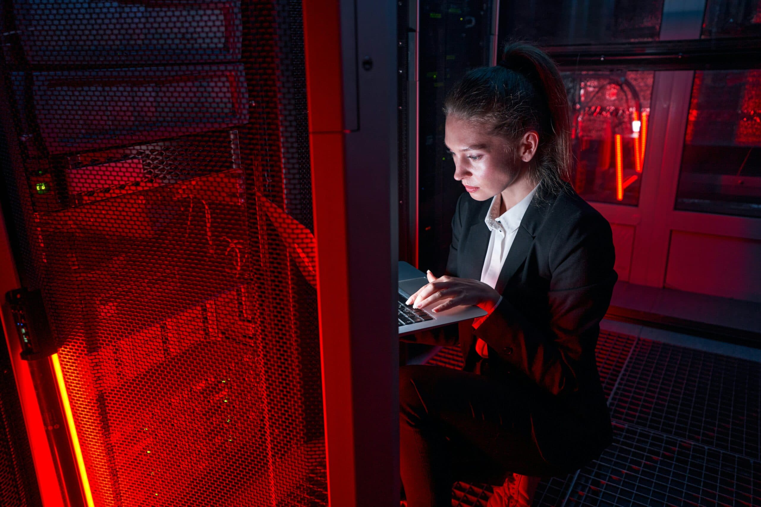 A woman working in a server room at night explores 10 ways to protect your computer from hackers.