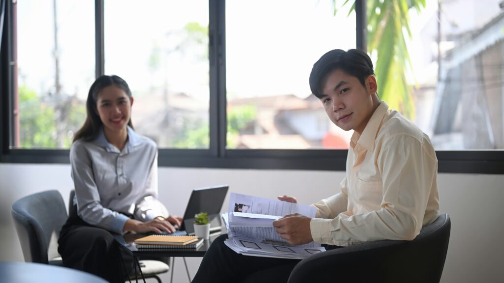 Two professionals in an office setting providing remote managed services.